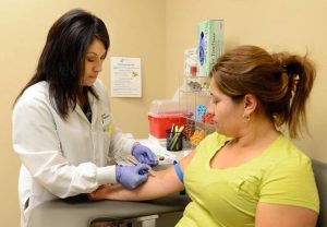 HC0225C Susana Cervantes draws blood on patient Aug 20 2013 By The Fresno Bee