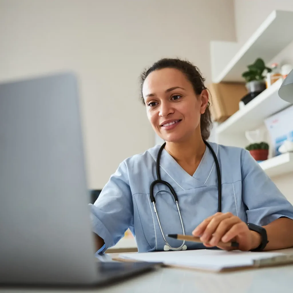 Doctor clicking on a laptop