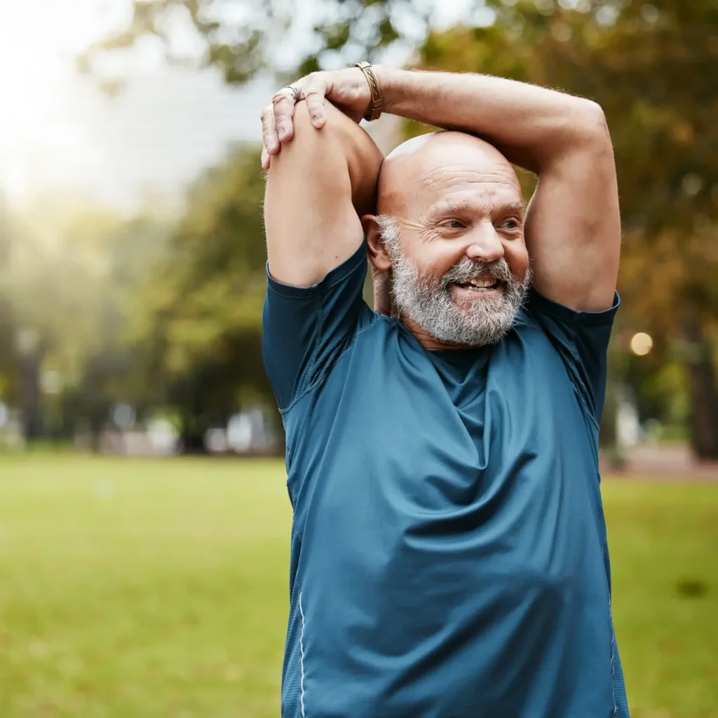Senior runner in stretching in the park