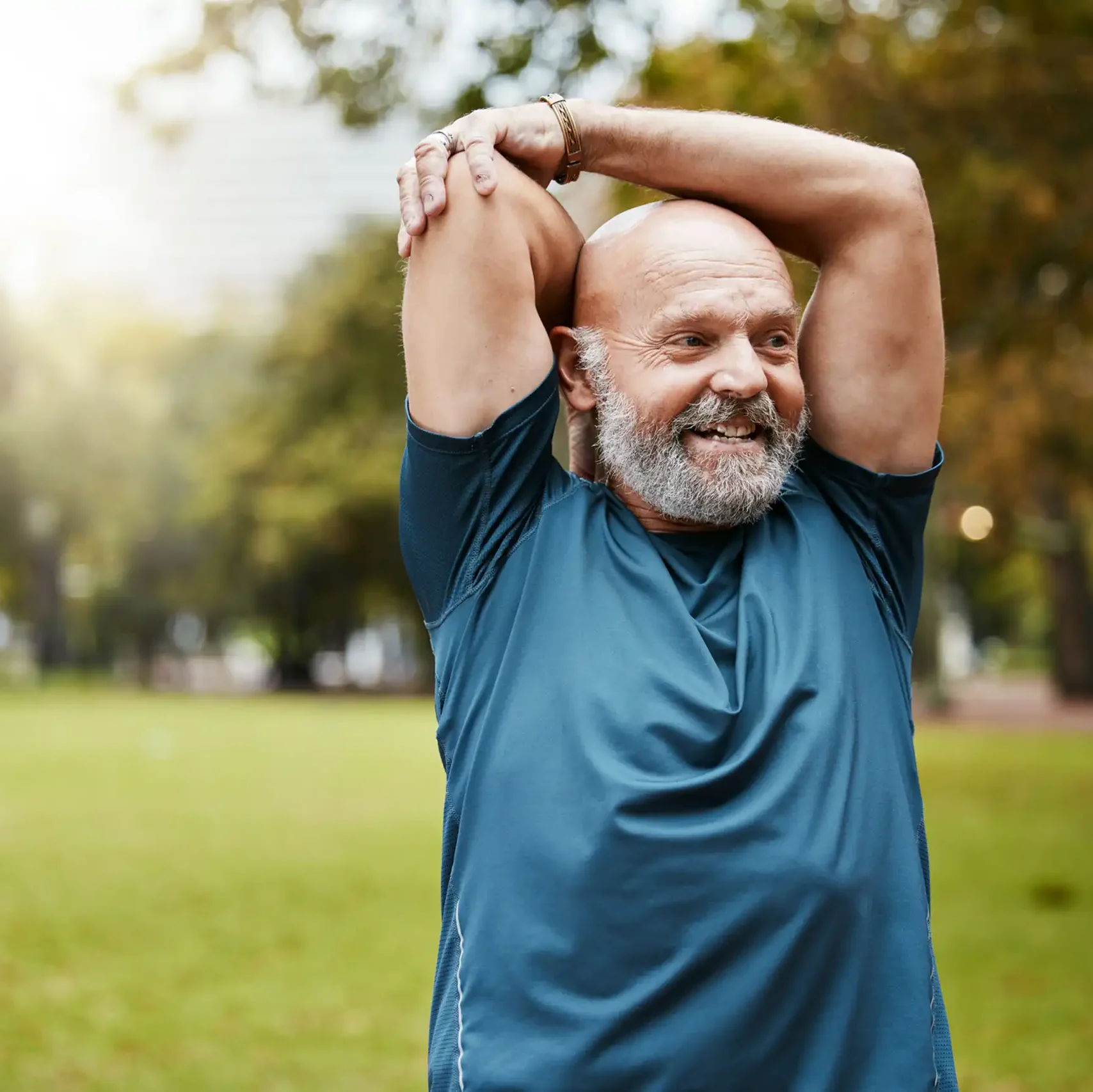 Senior runner in stretching in the park